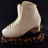 Lumberjack plaid blade soakers shown on a figure skate