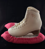 Pink blade soakers shown on a figure skate