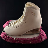 Pink floral blade soakers shown on a figure skate