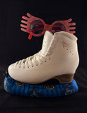 Blue and bronze wizard house inspired blade soakers shown on a figure skate
