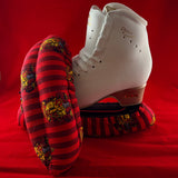 Red and gold wizard house inspired blade soakers shown on a figure skate