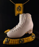 Yellow and black wizard house inspired blade soakers shown on a figure skate
