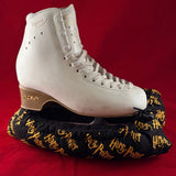 Wizard school print blade soakers shown on a figure skate
